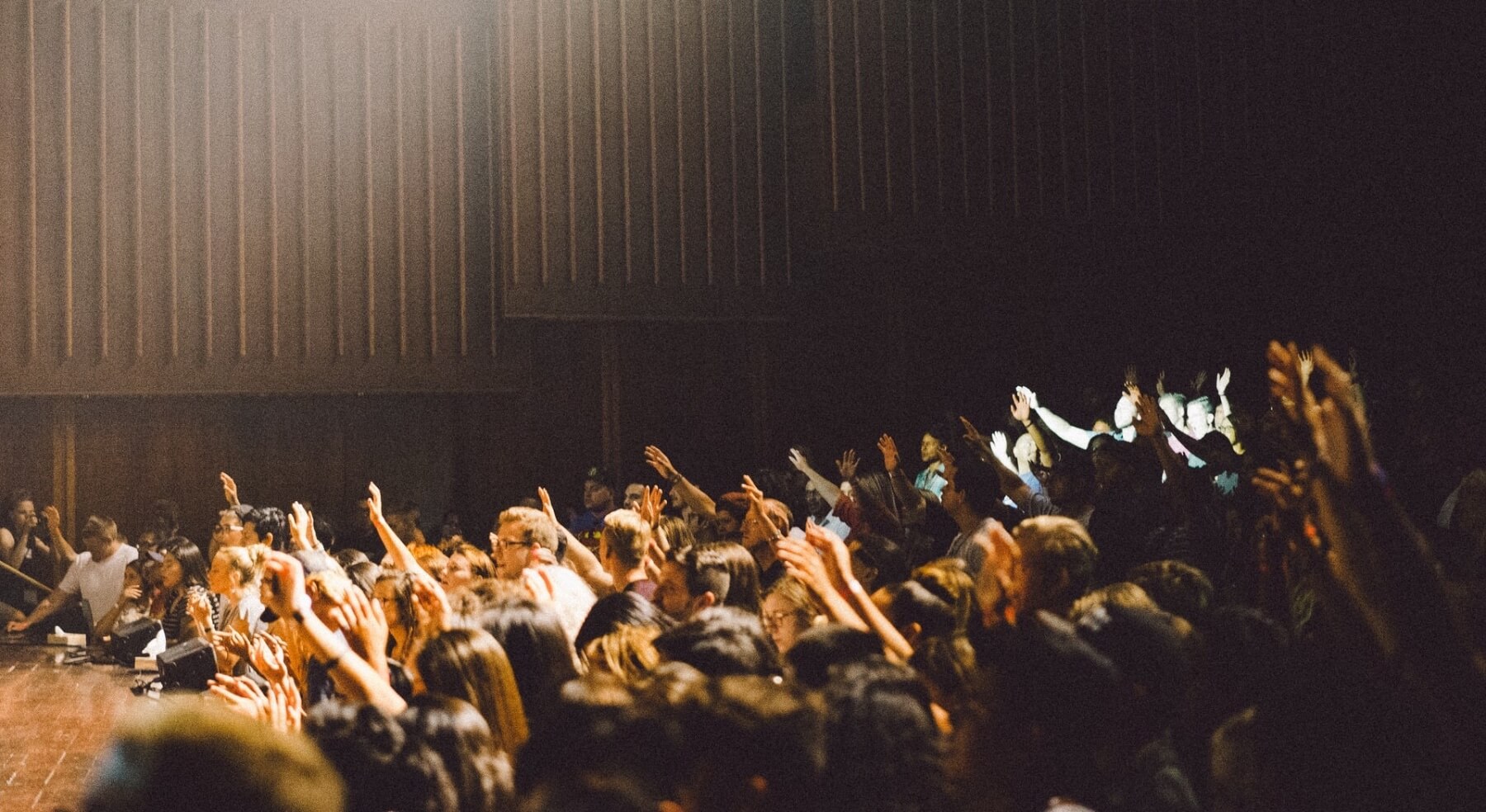 An audience raising arms for questions